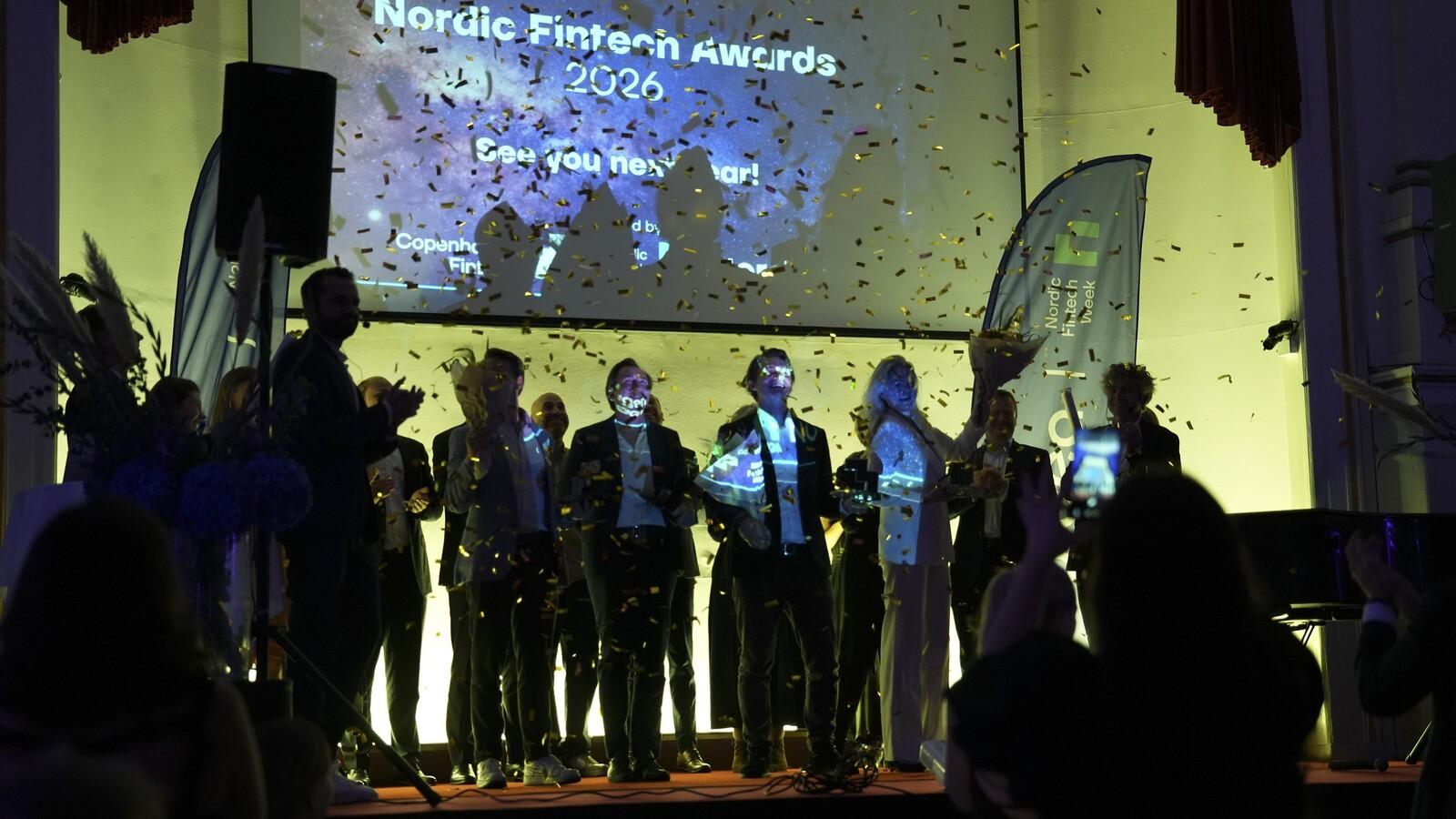 The wamo team on stage under gold confetti, celebrating a win at the 2026 Nordic Fintech Awards in Copenhagen